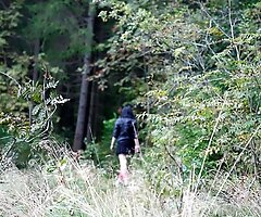 Naughty brunette pisses into a sandpit in forest