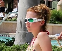 Sexy bikini babes sit on the beach